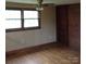 Bright bedroom featuring hardwood floors, a ceiling fan and ample natural light from a large window at 1700 Old Spencer Mountain Rd, Dallas, NC 28034