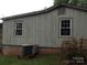 Exterior view of the home's siding with a window and part of the HVAC at 1700 Old Spencer Mountain Rd, Dallas, NC 28034