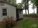 Exterior view of the home showing the siding, windows and backyard at 1700 Old Spencer Mountain Rd, Dallas, NC 28034