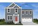 Two-story home featuring gray siding, a red front door, and a two-car garage at 177 Basildon St # 1014, Lancaster, SC 29720