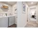 Conveniently located laundry room with washer, dryer and storage shelf at 177 Basildon St # 1014, Lancaster, SC 29720