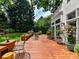 Spacious back deck features outdoor seating, potted plants, and manicured landscaping at 19205 Hidden Cove Ln, Cornelius, NC 28031