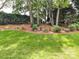 Backyard with a lush lawn and ornamental landscape elements, offering a serene outdoor space at 19205 Hidden Cove Ln, Cornelius, NC 28031