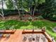 Lush backyard with a spacious deck, shaded by mature trees and featuring outdoor seating at 19205 Hidden Cove Ln, Cornelius, NC 28031