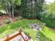 Expansive backyard features a stone fire pit surrounded by Adirondack chairs, perfect for outdoor entertaining at 19205 Hidden Cove Ln, Cornelius, NC 28031