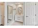 Bright bathroom featuring a white vanity with marble countertop and two decorative mirrors at 19205 Hidden Cove Ln, Cornelius, NC 28031
