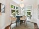 Cozy breakfast nook features natural light, a modern chandelier, and a view to the backyard at 19205 Hidden Cove Ln, Cornelius, NC 28031