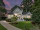 Elegant home featuring a manicured lawn, landscaped garden, and inviting front facade exuding curb appeal at 19205 Hidden Cove Ln, Cornelius, NC 28031