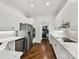 Bright kitchen with white cabinets, stainless steel appliances and hardwood floors at 19205 Hidden Cove Ln, Cornelius, NC 28031