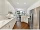 Bright kitchen featuring white cabinets, stainless steel appliances and hardwood floors at 19205 Hidden Cove Ln, Cornelius, NC 28031