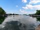 Picturesque lake with multiple docks, showcasing a waterfront lifestyle and recreational opportunities at 19205 Hidden Cove Ln, Cornelius, NC 28031