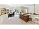 Bright office space with built-in shelves and a desk, connecting to a private balcony for a serene workspace at 19205 Hidden Cove Ln, Cornelius, NC 28031