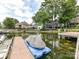 Stunning waterfront property featuring a private dock and boat lift amidst lush landscaping and luxurious homes at 19205 Hidden Cove Ln, Cornelius, NC 28031
