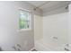 Bathroom with a combination shower and tub, featuring a single window at 203 Hickory Wood Dr, Kannapolis, NC 28083