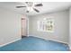 Bright bedroom features a ceiling fan, window, and door leading to other rooms at 203 Hickory Wood Dr, Kannapolis, NC 28083
