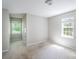 Empty bedroom featuring two windows, light colored walls and carpeting at 203 Hickory Wood Dr, Kannapolis, NC 28083
