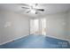 Bedroom showcasing a ceiling fan, natural light from windows, and an open doorway at 203 Hickory Wood Dr, Kannapolis, NC 28083