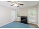 Bedroom with a ceiling fan, natural light, a fireplace, and an exterior door at 203 Hickory Wood Dr, Kannapolis, NC 28083
