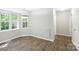 Dining area with contemporary lighting, many windows, and updated floors at 203 Hickory Wood Dr, Kannapolis, NC 28083