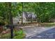 Traditional home showcasing a two-car garage and lovely front yard with mature trees at 203 Hickory Wood Dr, Kannapolis, NC 28083