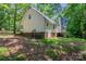 The home's rear exterior has brick foundation, siding, and partial shade at 203 Hickory Wood Dr, Kannapolis, NC 28083
