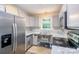 Kitchen features stainless steel appliances, granite countertops, and natural light at 203 Hickory Wood Dr, Kannapolis, NC 28083