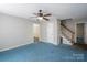 Spacious living room with ceiling fan, staircase, and multiple entryways at 203 Hickory Wood Dr, Kannapolis, NC 28083