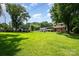 Spacious backyard with lush green grass, mature trees, and a shed offers plenty of room for outdoor activities at 2109 Quail Nw Dr, Concord, NC 28027