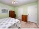 Cozy bedroom featuring a ceiling fan, window with blinds, and neutral-colored walls and carpet at 2109 Quail Nw Dr, Concord, NC 28027