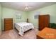 Bright bedroom with fresh green paint, ceiling fan, and neutral-toned carpet at 2109 Quail Nw Dr, Concord, NC 28027