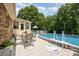 Outdoor deck features a table with chairs, lounge seating, and an above-ground pool with a white fence and stairs at 2109 Quail Nw Dr, Concord, NC 28027