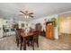 Cozy dining room featuring a wooden table set, ceiling fan, and open access to the modern kitchen at 2109 Quail Nw Dr, Concord, NC 28027