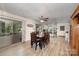 Cozy dining room featuring a wooden table set, ceiling fan, and open access to the screened porch and kitchen at 2109 Quail Nw Dr, Concord, NC 28027