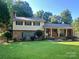 Charming two-story home featuring a brick facade, landscaped yard, and covered porch, perfect for relaxation and curb appeal at 2109 Quail Nw Dr, Concord, NC 28027