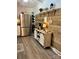 Well-equipped kitchen with stainless steel refrigerator, a built-in beverage cooler, and a wood accent wall at 2109 Quail Nw Dr, Concord, NC 28027