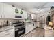 Well-lit kitchen featuring stainless steel appliances, granite countertops, and ample cabinetry at 2109 Quail Nw Dr, Concord, NC 28027