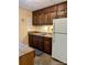 Functional kitchen with wood cabinets, durable countertops, a refrigerator, and a tile floor at 2109 Quail Nw Dr, Concord, NC 28027