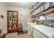 Functional laundry area featuring a washer, dryer, shelving, and ample storage space at 2109 Quail Nw Dr, Concord, NC 28027