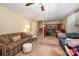 Spacious living area featuring plush seating, an adjacent staircase, and a built-in bookcase at 2109 Quail Nw Dr, Concord, NC 28027