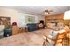 Spacious living room featuring a brick fireplace, large window, comfortable seating and ceiling fan at 2109 Quail Nw Dr, Concord, NC 28027