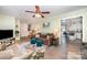 Inviting living room featuring neutral walls, ceiling fan, comfortable seating, and open access to the kitchen at 2109 Quail Nw Dr, Concord, NC 28027