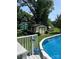 Backyard pool area featuring a deck, charming shed, and lush landscaping, providing a private and relaxing retreat at 2109 Quail Nw Dr, Concord, NC 28027