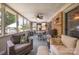 Enclosed sunroom featuring ample seating, a brick wall, and windows providing natural light at 2109 Quail Nw Dr, Concord, NC 28027