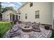 Lovely backyard featuring a patio with a fire pit and multiple chairs for entertaining at 220 Holmes Ct, Concord, NC 28027
