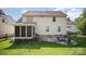 Spacious backyard featuring brick patio with fire pit, grill, and fenced yard at 220 Holmes Ct, Concord, NC 28027