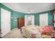 Green bedroom with double closets, neutral carpet, ceiling fan, and a view into ensuite bathroom at 220 Holmes Ct, Concord, NC 28027