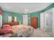Green bedroom featuring neutral carpet, ceiling fan, and a view into ensuite bathroom at 220 Holmes Ct, Concord, NC 28027