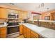 Well-equipped kitchen with stainless steel appliances, light cabinets, and mosaic tile backsplash at 220 Holmes Ct, Concord, NC 28027