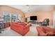 Spacious living room with comfortable seating, neutral carpet, multiple windows, and a ceiling fan at 220 Holmes Ct, Concord, NC 28027