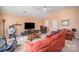 Cozy living room featuring comfortable seating, a ceiling fan and natural light at 220 Holmes Ct, Concord, NC 28027